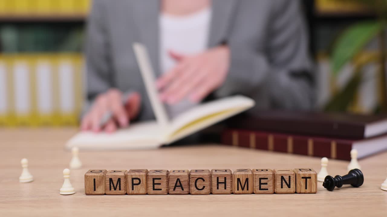 Impeachment Concept with Wooden Cubes and Chess Pieces