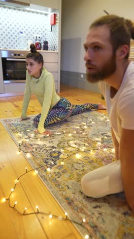 couple doing yoga at home