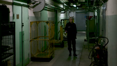 Female-safety-guard-with-flashlight-in-a-warehouse