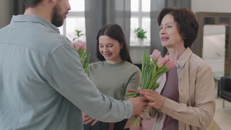 family celebrating with flowers