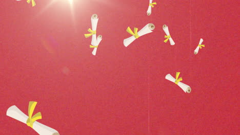 graduation scrolls with yellow ribbons rotating over red background