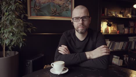 man sitting in a cafe with coffee