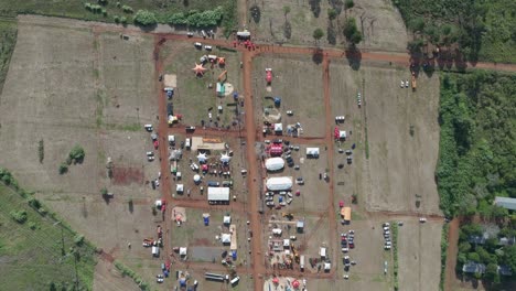 topdown view of forest farmers market offering goods of traders under big tents