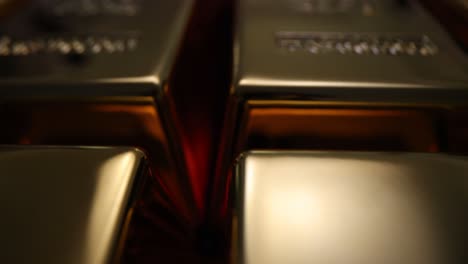 close-up view of shiny gold bars, some showing 'gold' and 'net wt' inscriptions