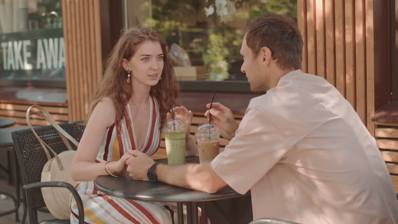 Woman Chatting with her Date in Cafe