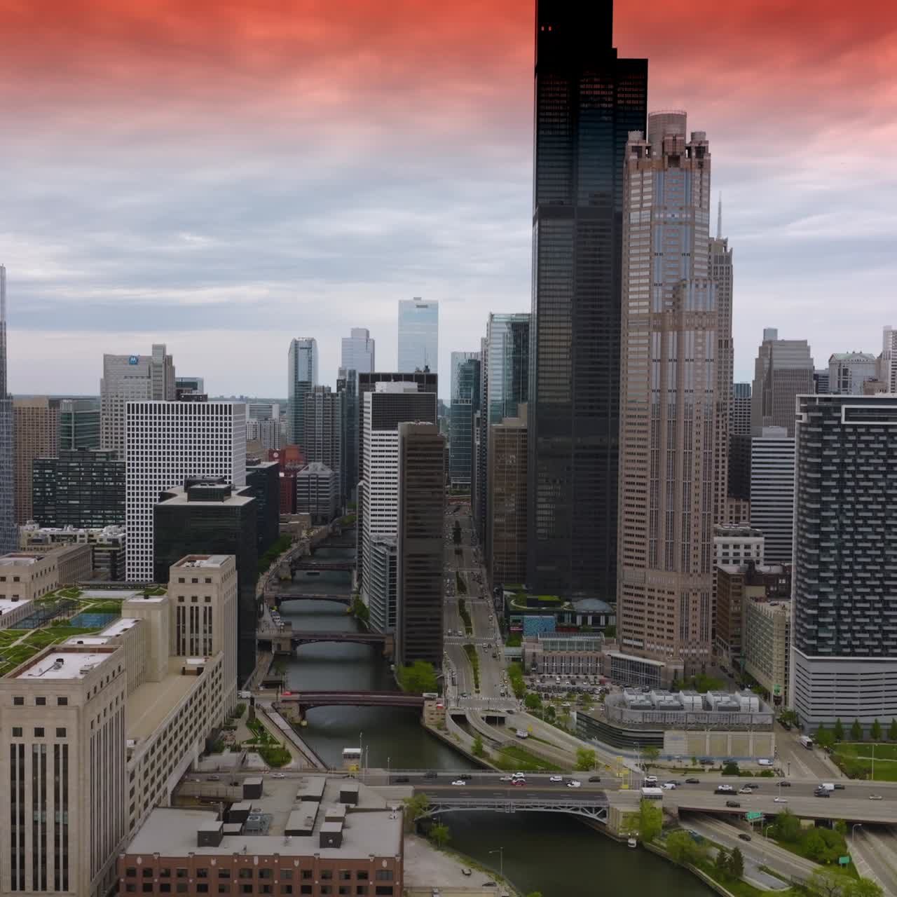 Transport traffic on the roads of busy Chicago at daytime. Beautiful skyscrapers towering over the streets of metropolis. Top view