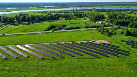 sun reflecting off solar panels in countryside farm, aerial orbit view