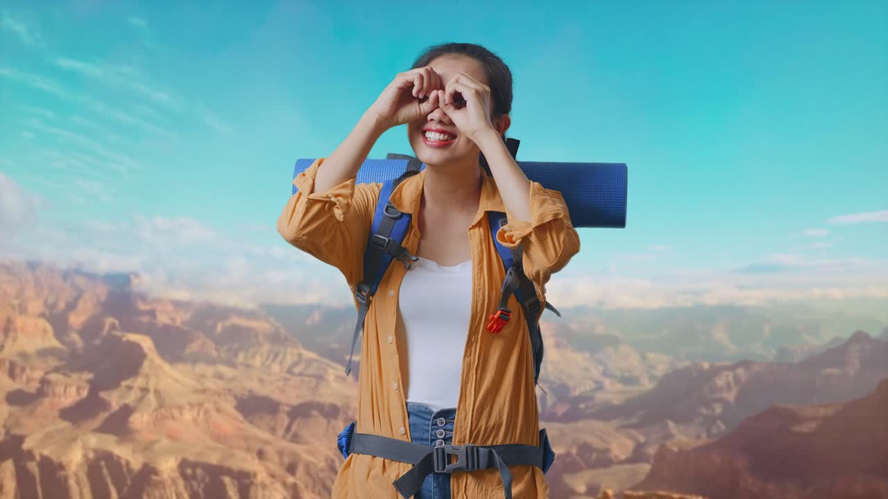 Asian Female Hiker With Mountaineering Backpack Making Binoculars Gesture Looking At Something Then Saying Wow While Traveling At The Top Of Mountain
