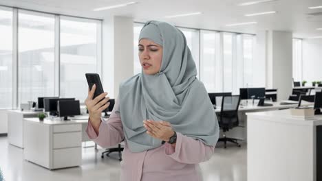 angry muslim businesswoman talking on video call