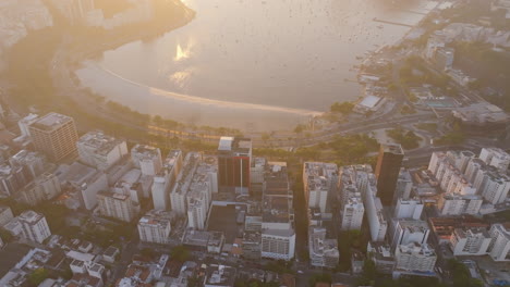 Wide-aerial-footage-of-the-neighborhood-of-Botafogo-that-pans-up-to-reveal-the-bay-and-Sugarloaf-mountain-in-the-background-during-the-sunrise-and-Rio-de-Janeiro