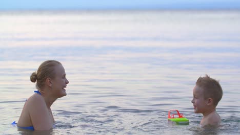 Mother-with-son-bathing-in-sea-and-having-fun