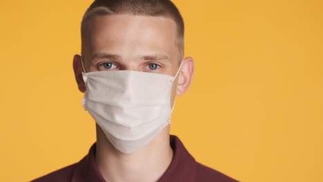 blue eyes guy wearing protective face mask