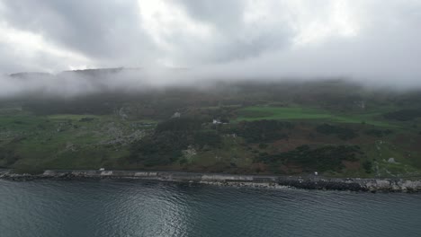 Aerial-dolly-shot-of-beautiful-cliffside-view-of-Fair-Head-in-Northern-Ireland-overlooking-the-pristine-nature-and-unique-destination-for-an-travel-adventure-for-hikers-and-climbers