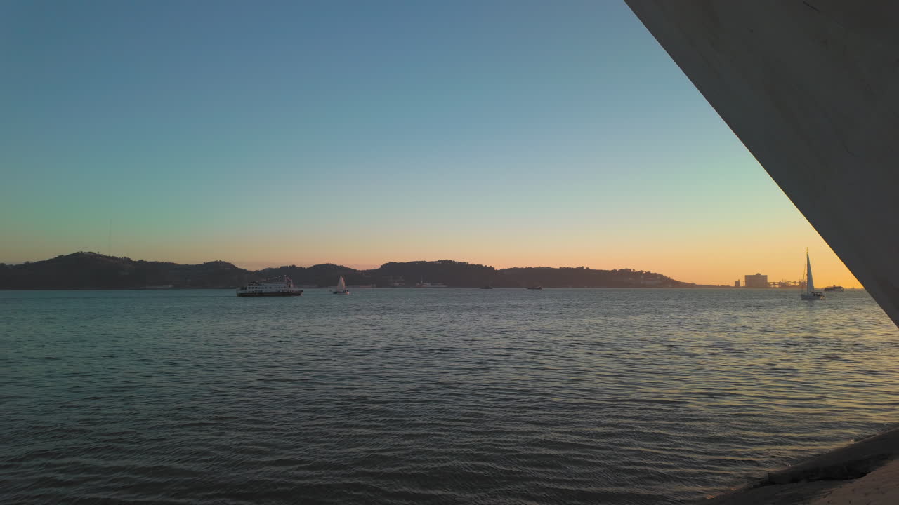 Panoramic view of the sunset on the Tagus river in Lisbon, Portugal, from right to left