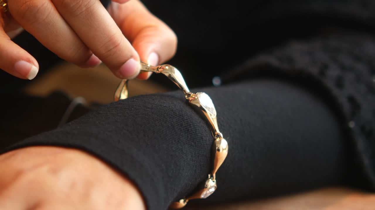 Gold Bracelet on Woman's Wrist