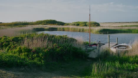 small sailboat at wooden jetty, pleasure craft for hobby and leisure