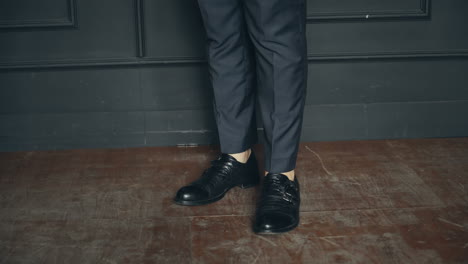 businessman standing in polished shoes. people, business, fashion and footwear concept - close up of man legs in elegant shoes