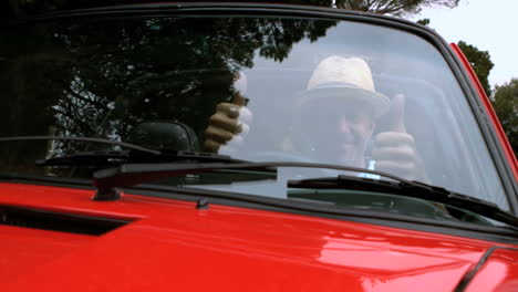 Man-raising-his-thumbs-up-in-the-car