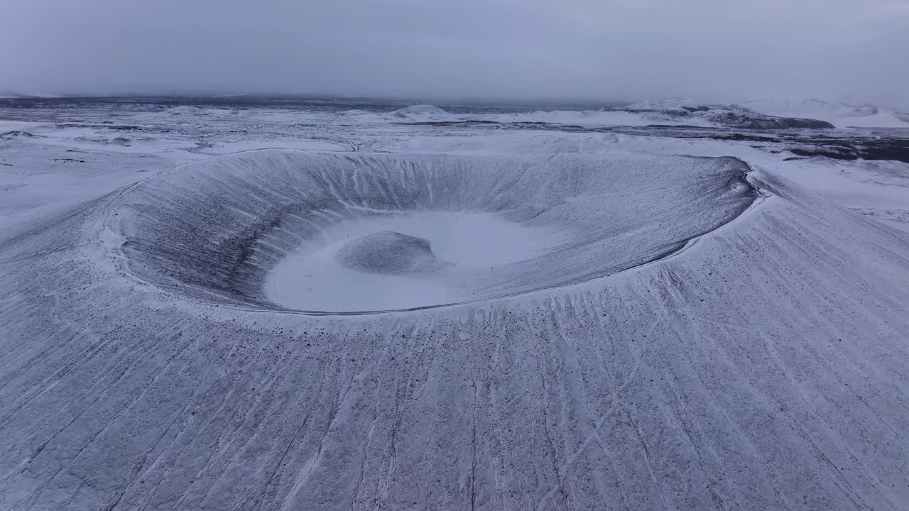 Lumen peittämä Hverfjall-tulivuoren kraatteri talvella Islannissa. Ilmakuva