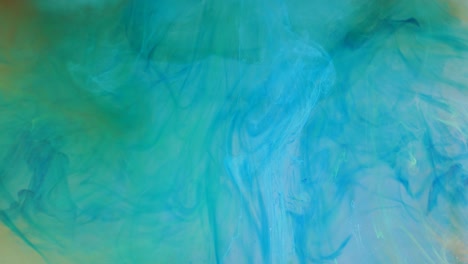 spreading of blue, green and white paint in a liquid pink space.