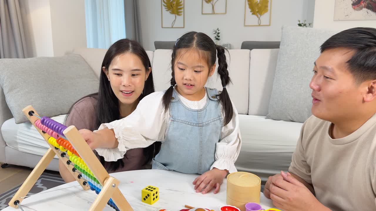 Asian family playing and learning with toys and abacus together in a cozy living room