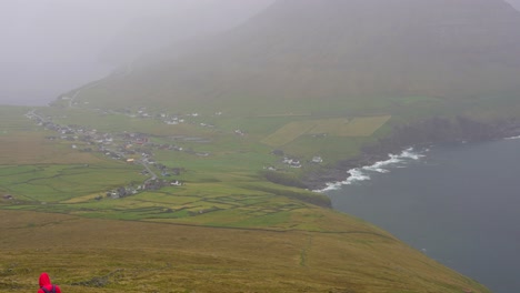 Woman-descends-Villingardalsfjall-in-foggy-weather,-returns-to-Vidareidi-village