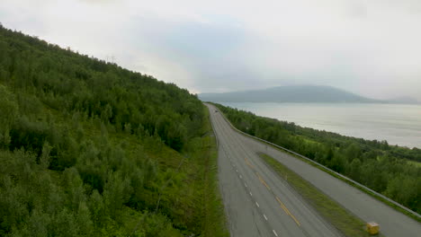 cars and semi-trailer truck driving on the european route e6 in nordkjosbotn, balsfjord, norway