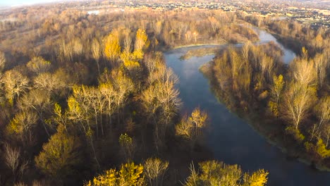 Overhead-aerial-of-a-meandering-river-during-a-bright-sunrise