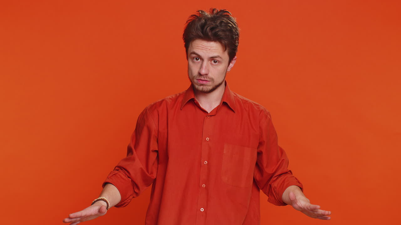 Young man says no hold palm folded crossed hands in stop gesture warning of finish prohibited access