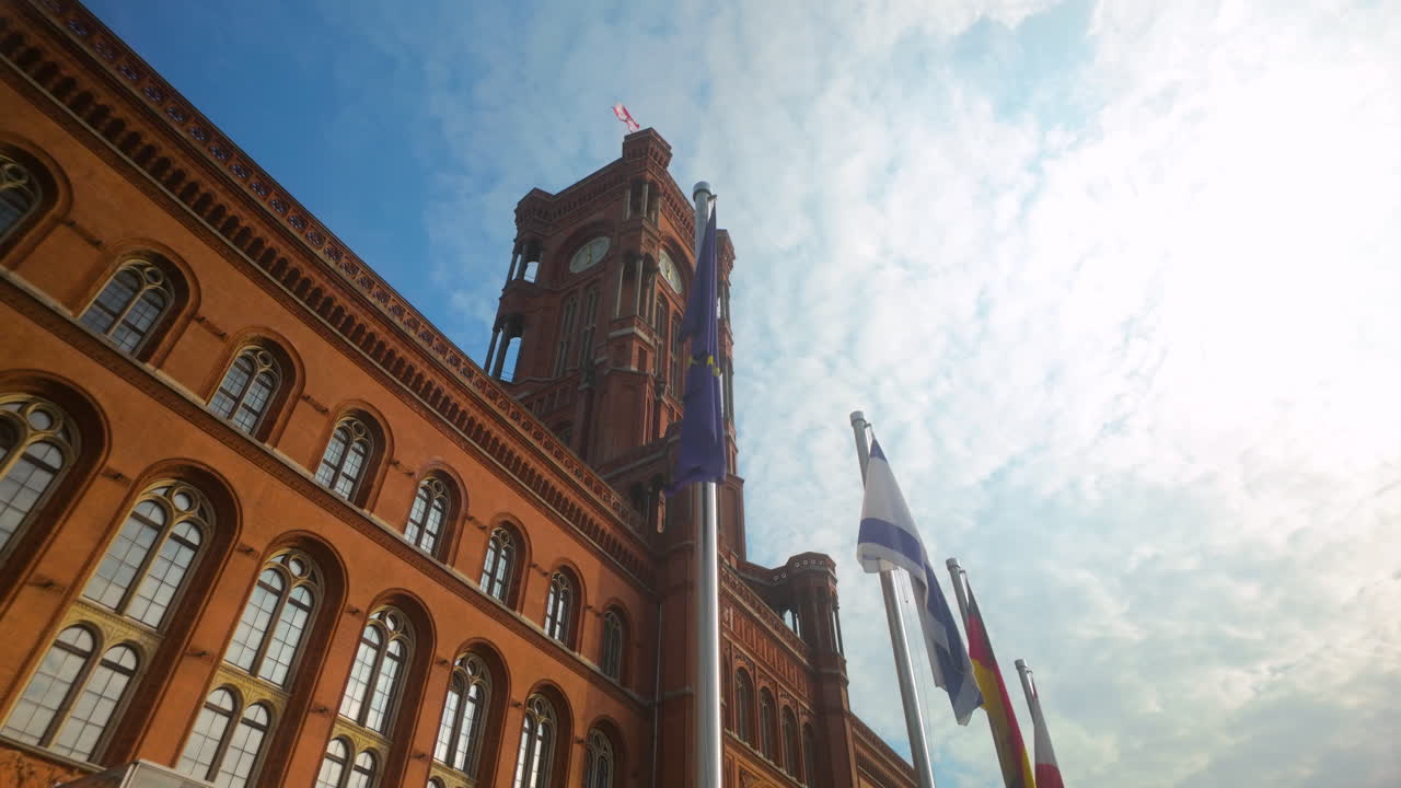 The towering Rotes Rathaus, Berlin’s iconic red city hall, under a partly cloudy sky, representing the city’s architectural and historical significance