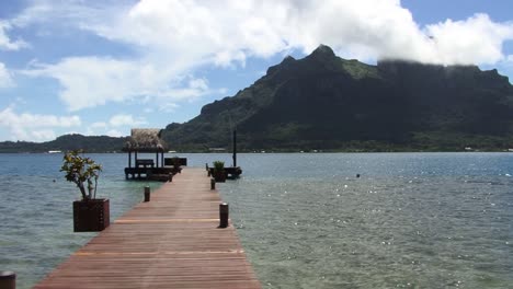 small pontoon in bora bora and view to mount otemanu, french polynesia