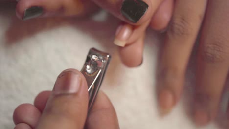 Closeup-Of-Manicurist-Clipping-Clients-Fingernail-During-Manicure