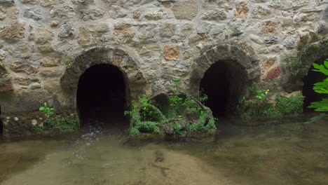 foundation of a building where a stream flows through