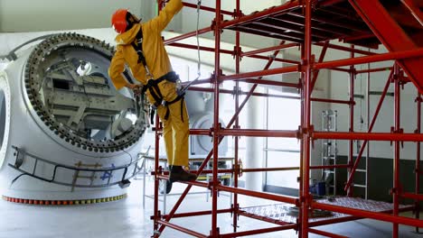 male worker climbing scaffolding at solar station 4k