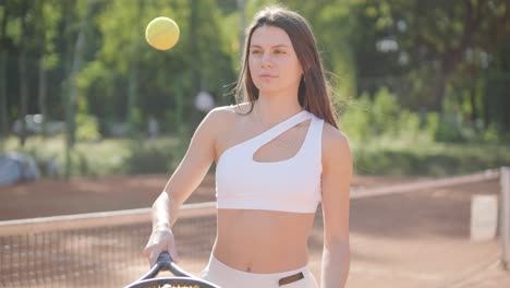 beautiful tennis girl practicing serve on outdoor court