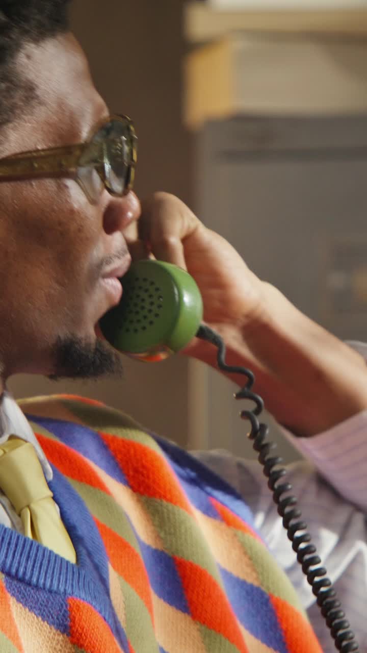 Man Talking on Vintage Phone in Office