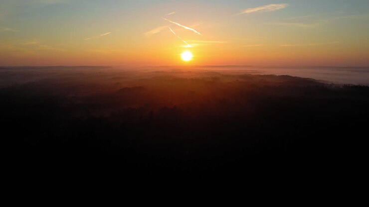 AERIAL - Beautiful sunset over Veluwe National Park, Netherlands, rising shot