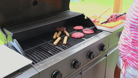 hamburger being flipped on a backyard grill