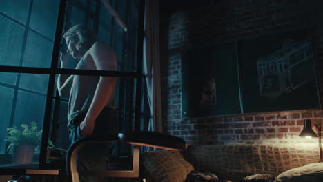 man in an urban apartment at night