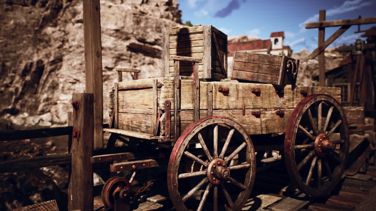 Rustic wooden cart on a dock beside rocky cliffs under a bright blue sky