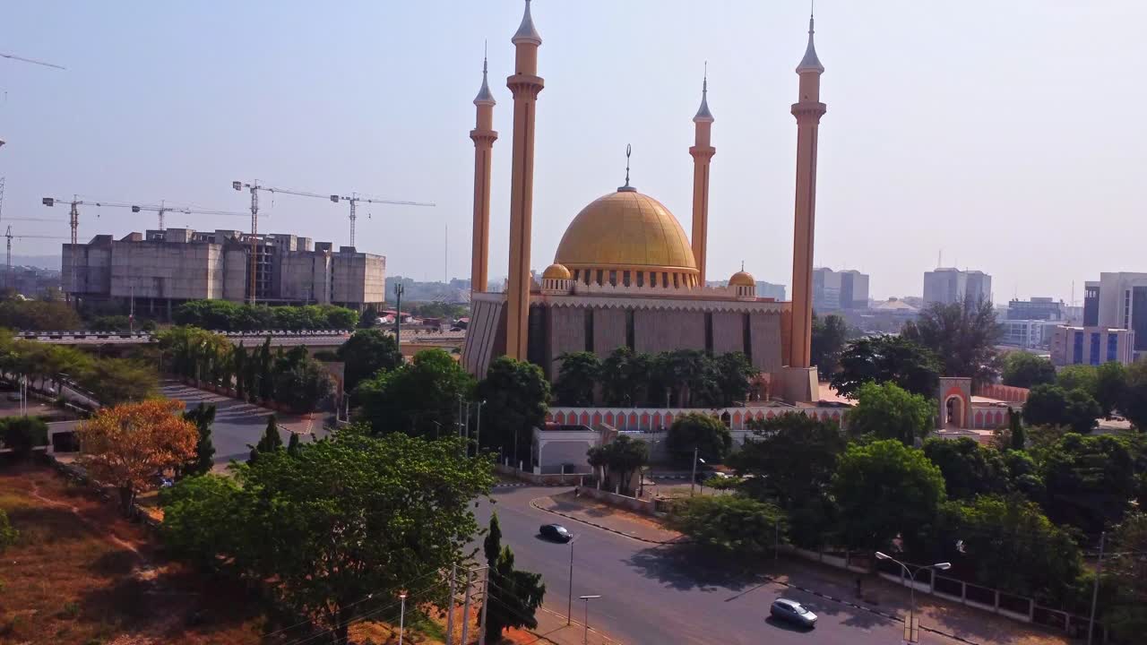 Wide view of the Abuja National Mosque with the skyline of the Abuja in the background