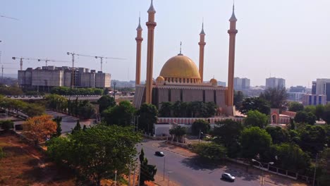 wide view of the abuja national mosque with the skyline of the abuja in the background