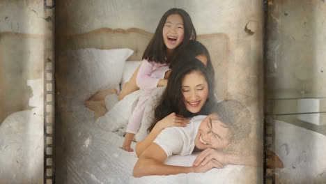 Cheerful-family-of-four-lying-over-each-other-in-bed