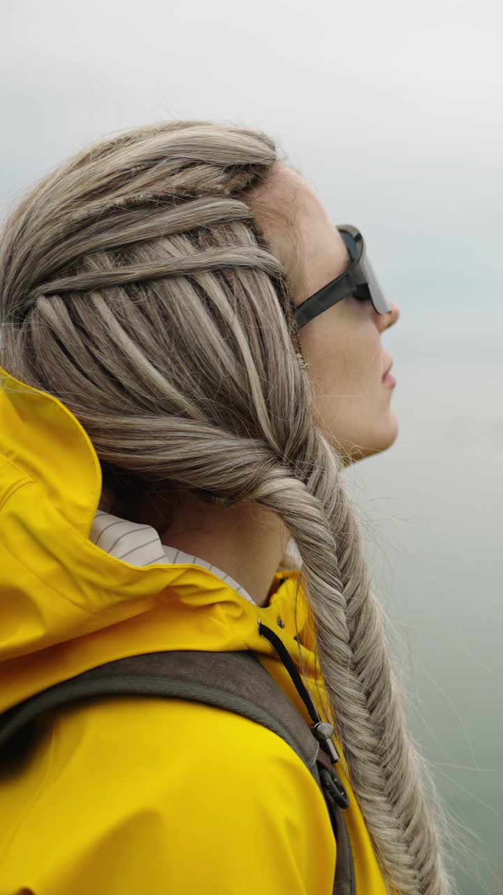 Woman in Yellow Raincoat Looking at Scenic Lake View
