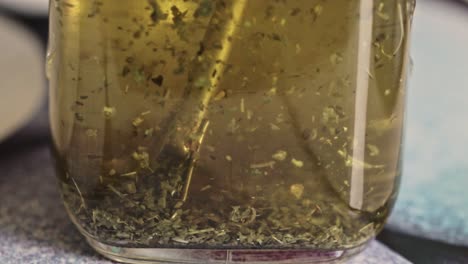 flaoting around yerba drought - green mate powder inside a glass jar