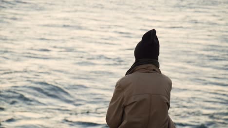 Slow-Motion-Of-Man-Watching-Sunset-In-Cam-Sea-View,-Cadiz,-Spain