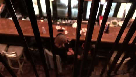 you see two women in a bar having a conversation from the perspective of the second floor
