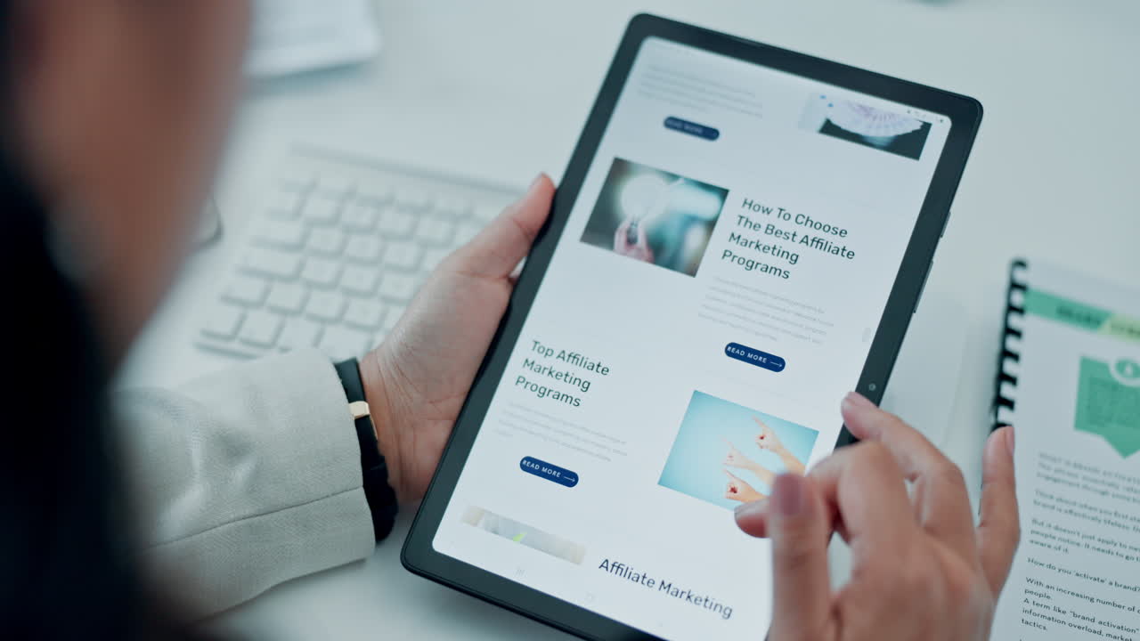 Close-up of Hands Scrolling Digital Tablet for Affiliate Marketing Research