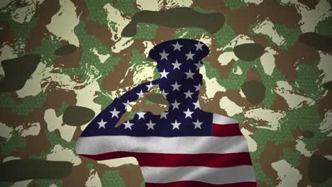 bandera estadounidense formando un soldado de saludo contra el fondo de camuflaje