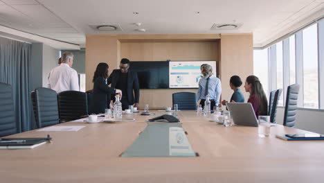 business people shaking hands meeting in boardroom preparing for conference collaborating with client shareholders planning partnership deal in corporate office